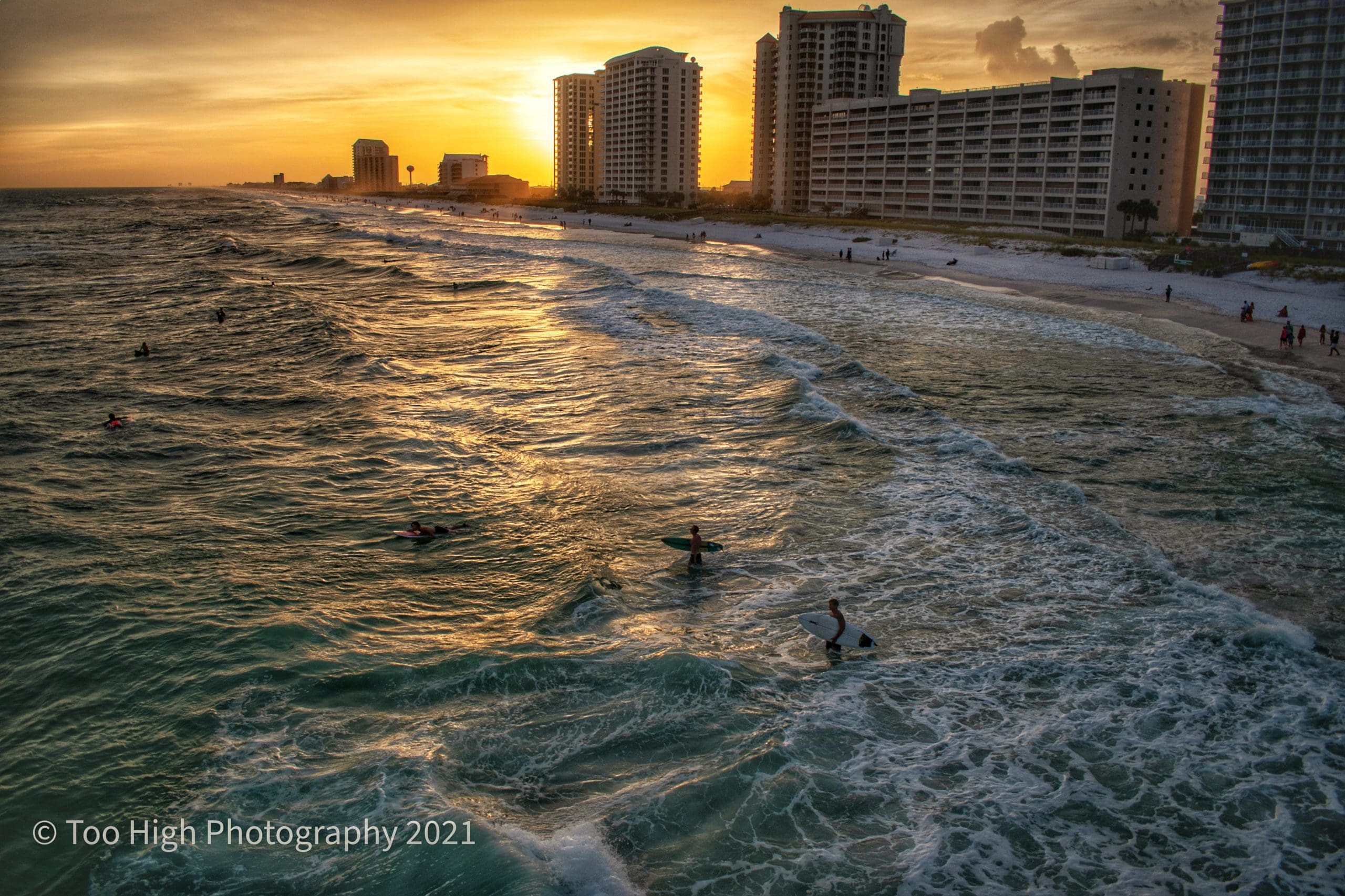 Today's Photo of the Day shows local surfers taking advantage of the high surf with a beautiful sunset backdrop. Photo submitted by Too High Photography.