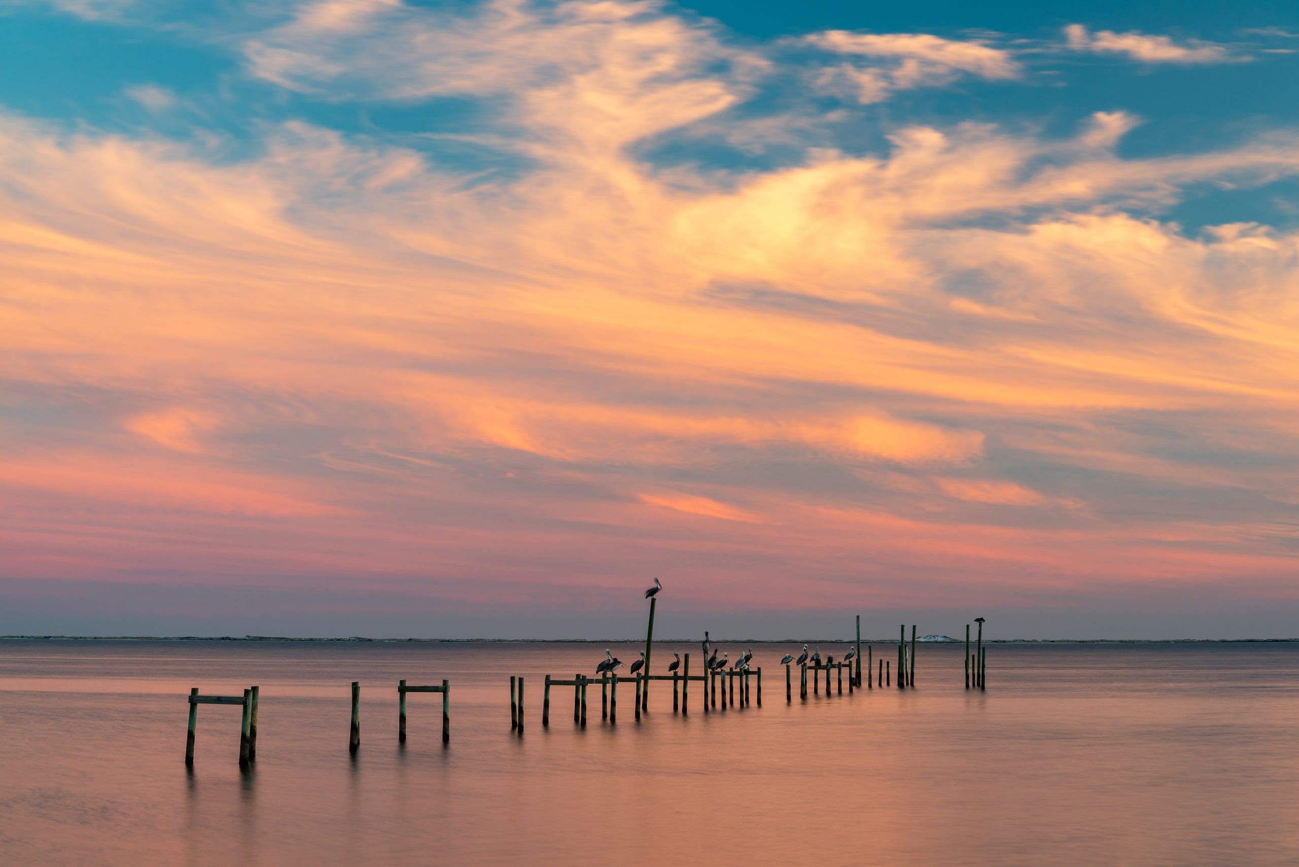 Today's Photo of the Day comes from Kevin Lehmann. Kevin took this photo of the sun setting along the Santa Rosa Sound. If you look closely, you'll see quite a few pelicans!