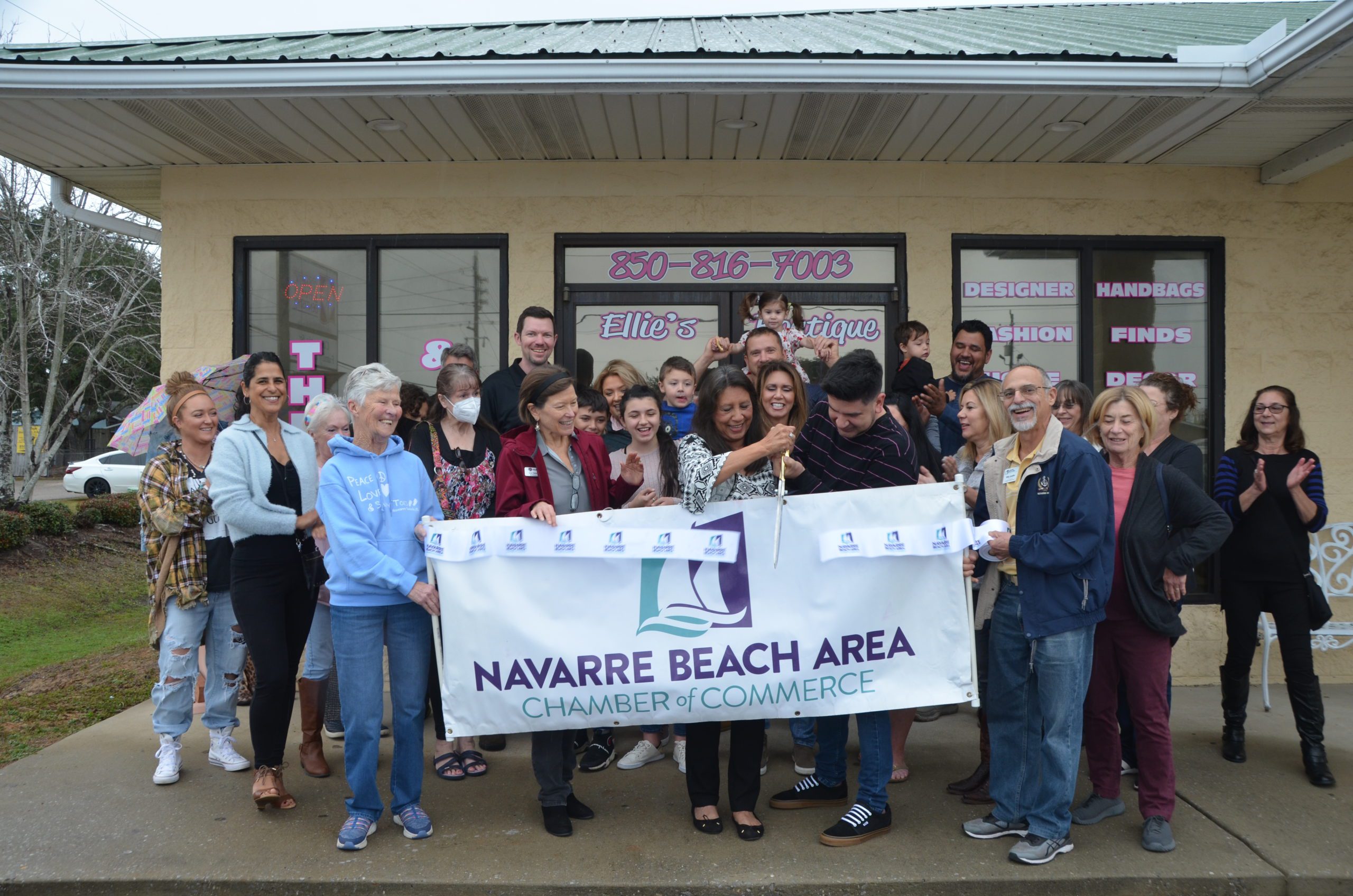 Ellie s Boutique cuts ribbon rain or shine Navarre Press