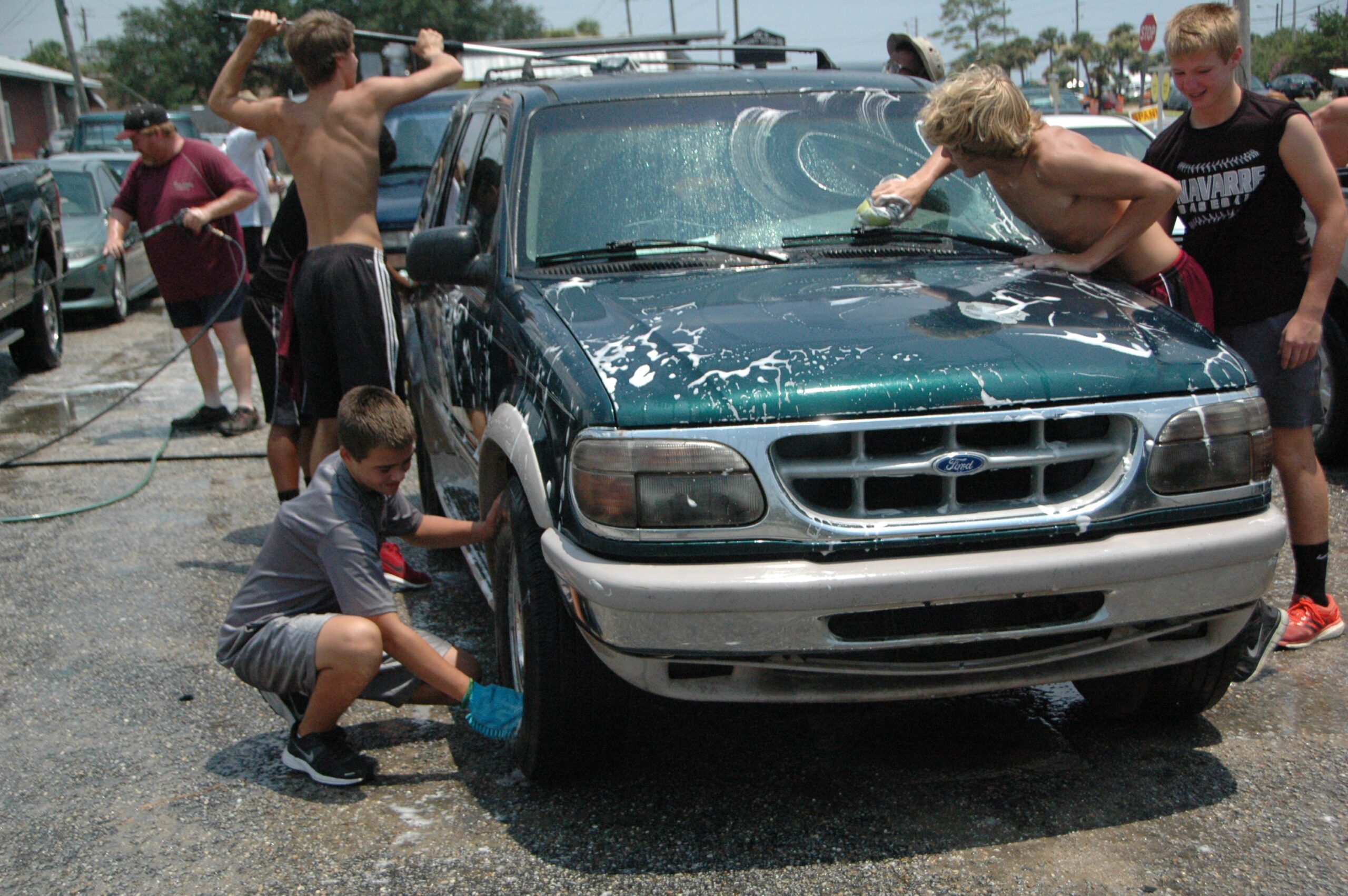 Football Players, Cheerleaders Cleaning Up 