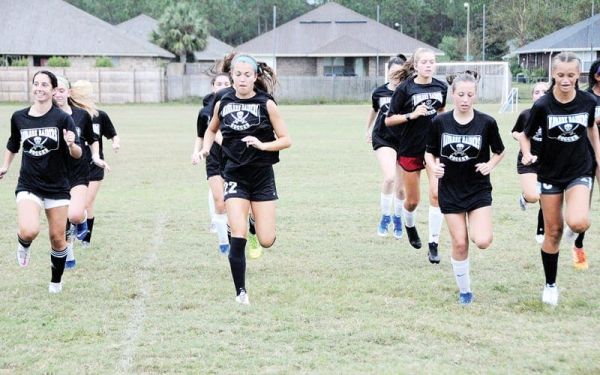 Navarre’s girls soccer team warms up before practice last week at the NYSA Soccer Complex.